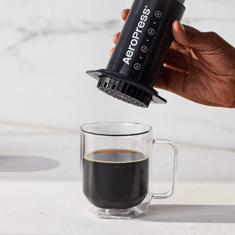 A person pressing coffee with the AeroPress Original