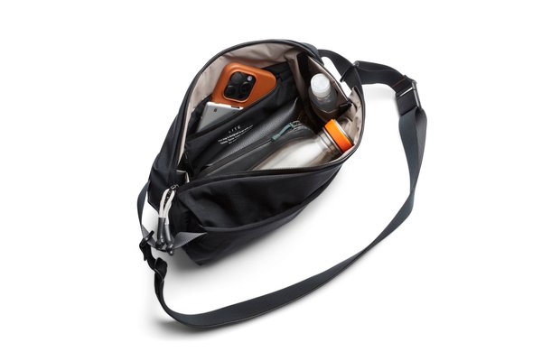 Bellroy Lite Sling opened to show its main compartment with manufacturer-styled contents