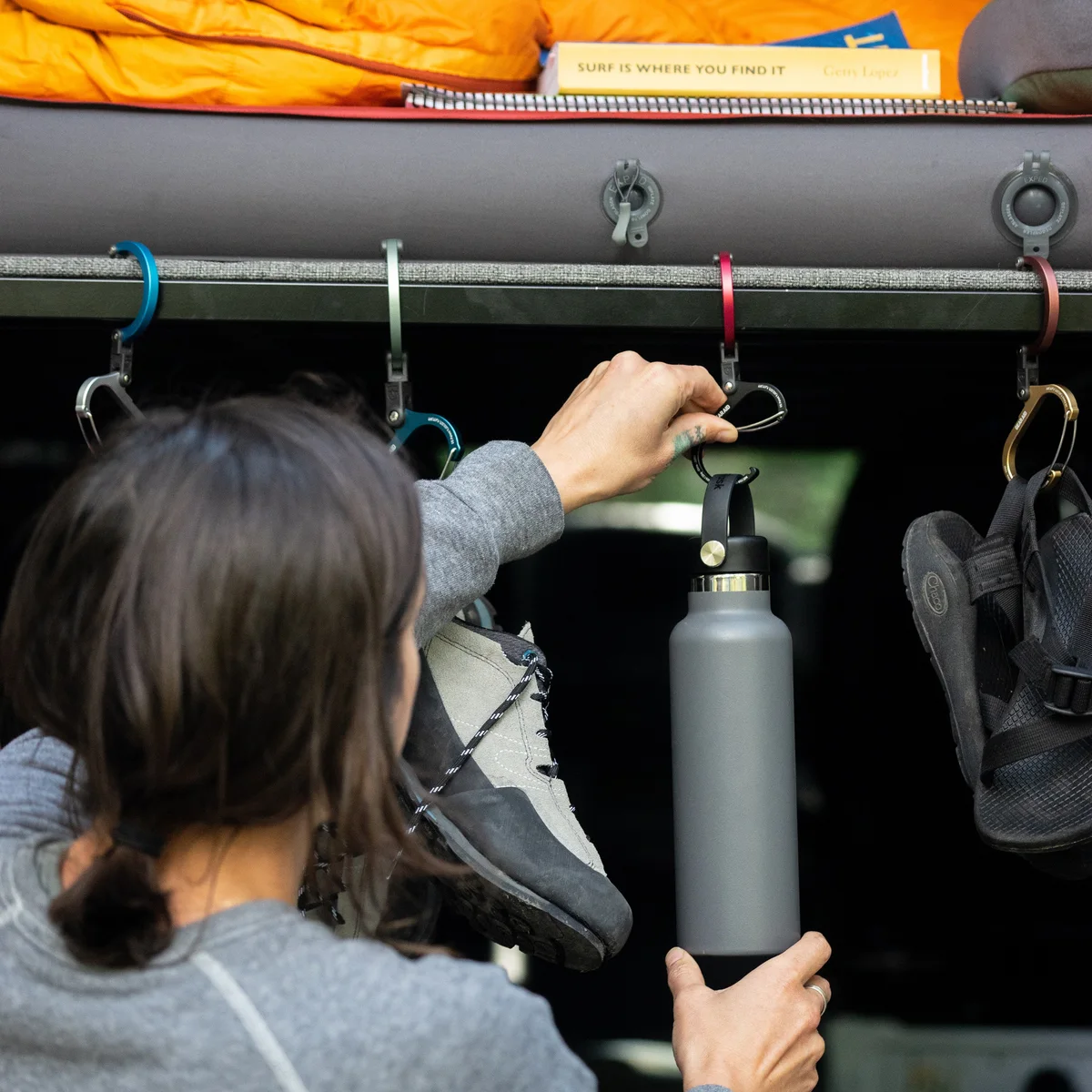 GEAR AID illustrative scene with several Heroclip colors and sizes hanging equipment