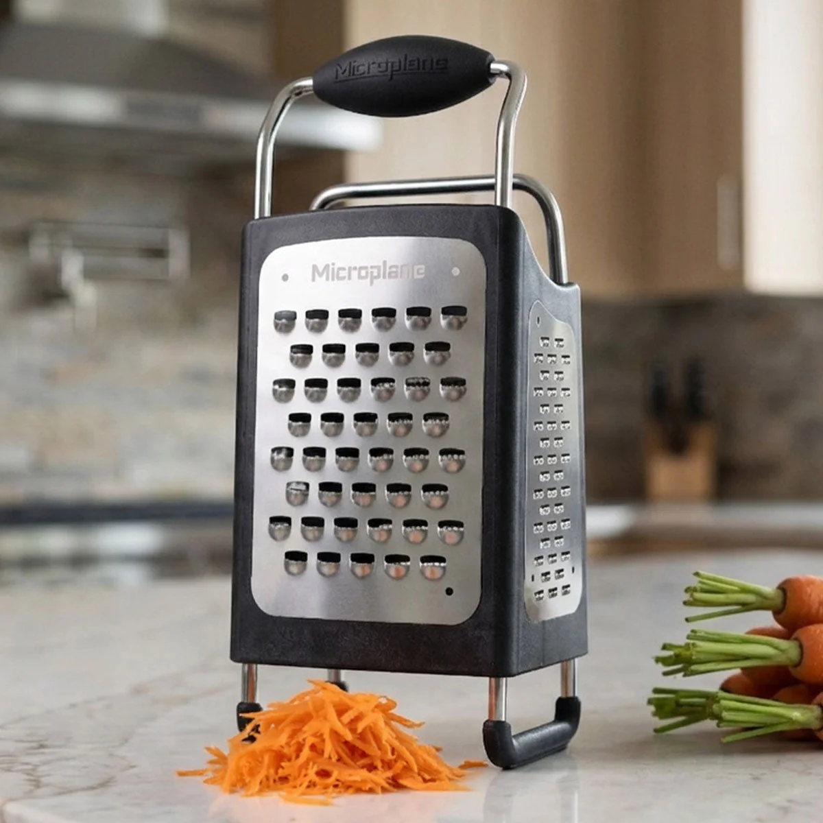 Four grating surfaces in a counter-standing frame; vegetables shown are styling props.