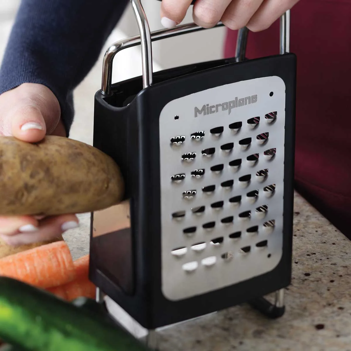 Coarse grating against the supported frame; stop before fingers approach the sharp surface.
