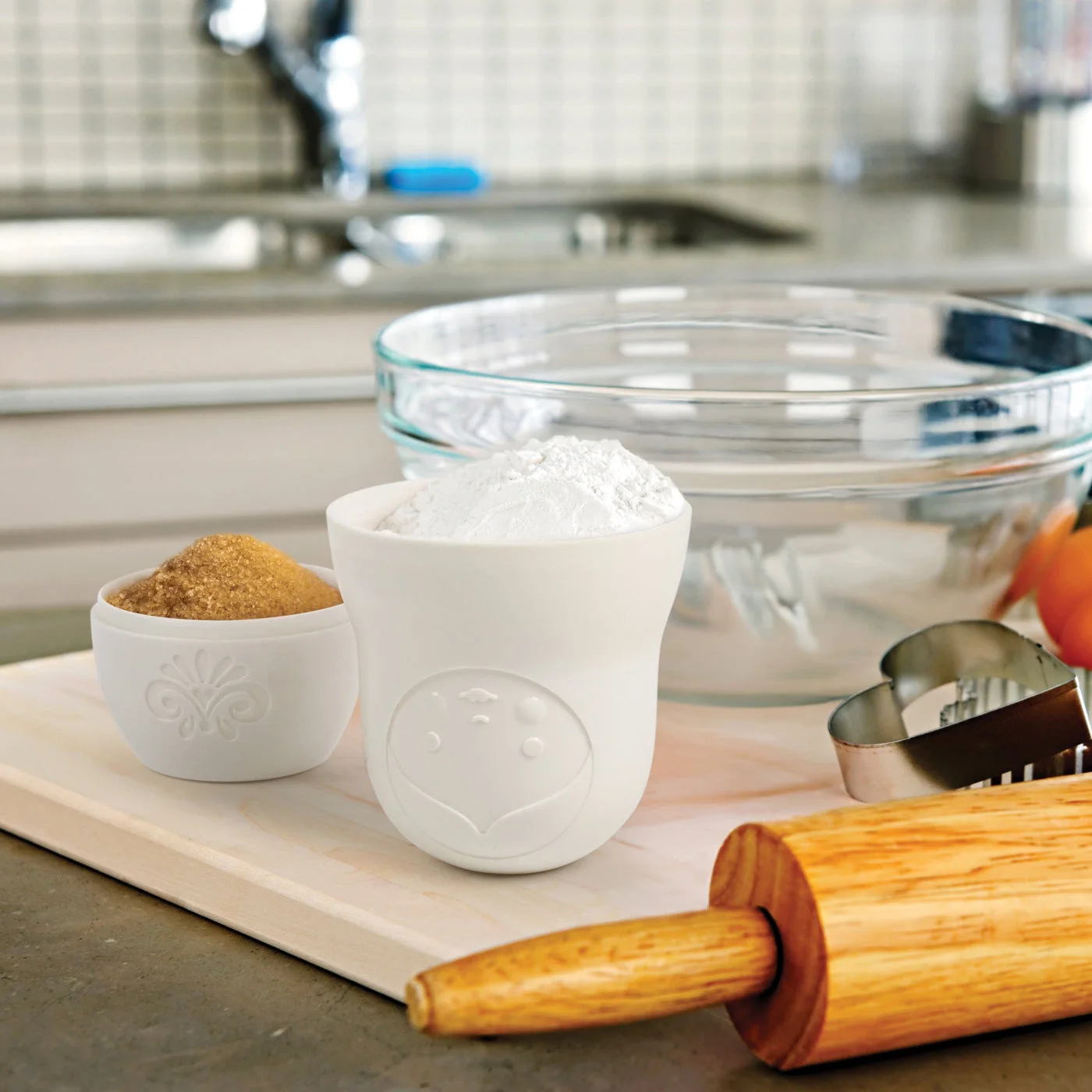 Dry ingredients measured beside baking tools; props not included.