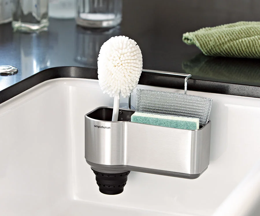 Caddy mounted inside a sink; brush andsponges are stylingprops.