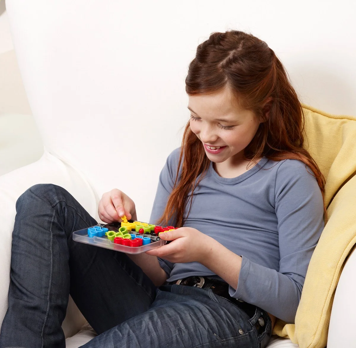 Manufacturer lifestyle photograph showing the compact board being held during play.