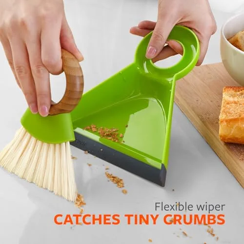 Flexible dustpan edge and short brushing motion shown on a countertop.