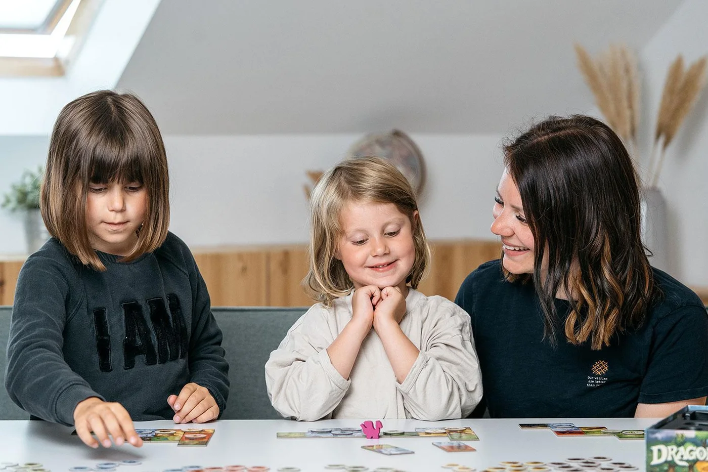 A second family-play reference image illustrates the tabletop format; this is not our personal testing.