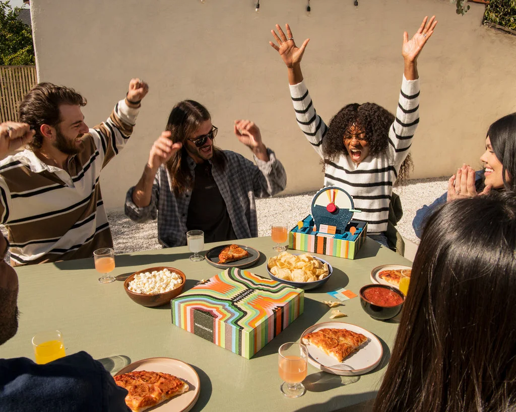Maker lifestyle photograph of a group playing; snacks, furniture and people are not included.