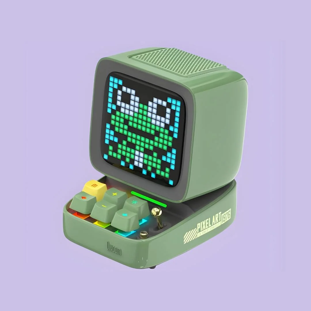 Green Ditoo against a purple backdrop, showing the small screen and keyboard-shaped controls.