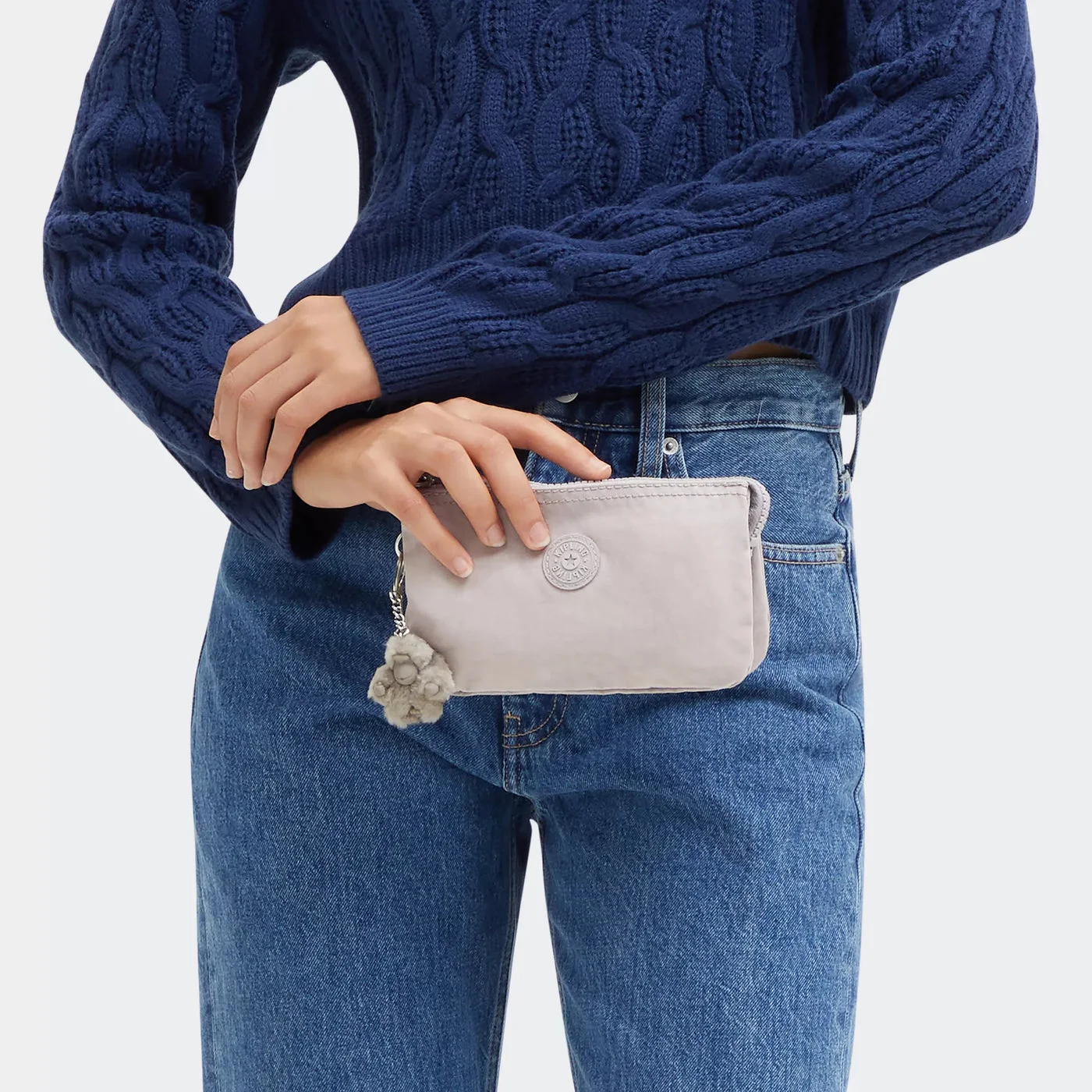 Pouch held against the body to show its modest size.