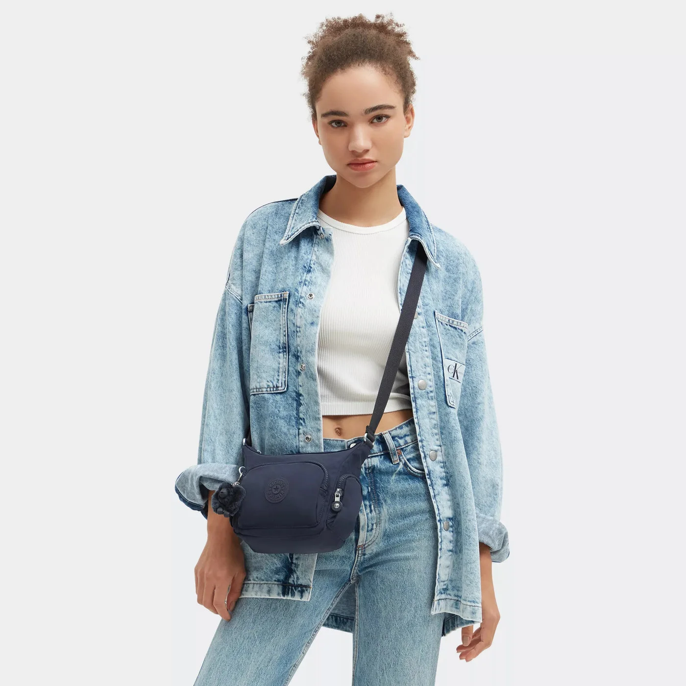 Manufacturer styling photograph for approximate carry scale, not a guarantee of strap fit.