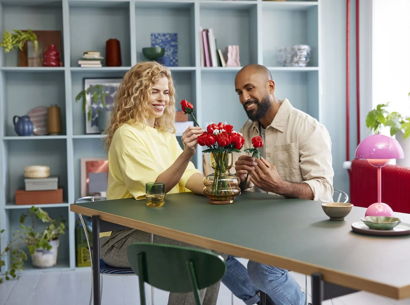 Two adults building the roses together; table props are not included.