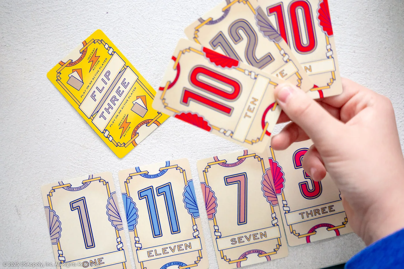 Modifier and number cards held above the table.