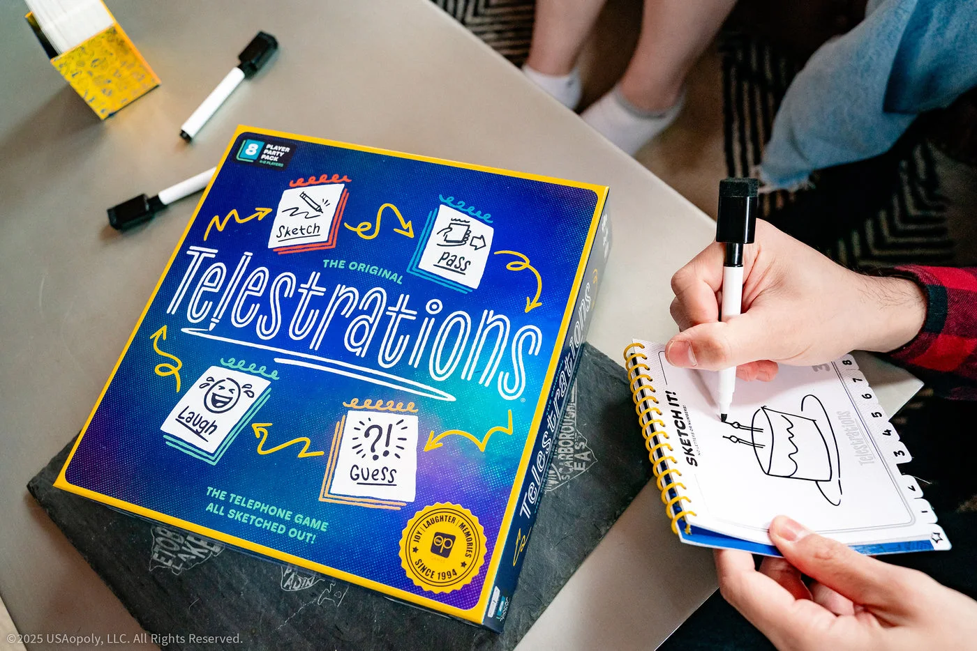 A player drawing beside the game box.
