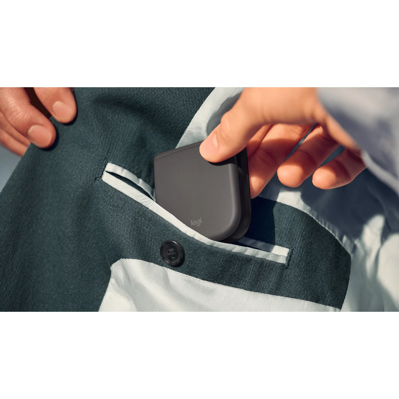 Closed mouse slipping into a pocket in a manufacturer travel scene.