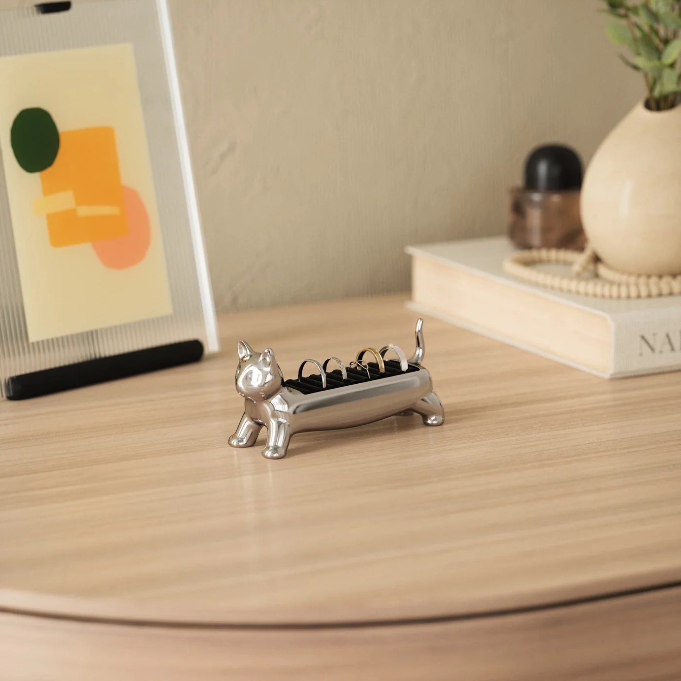 Chrome holder on a tabletop with household objects for display context