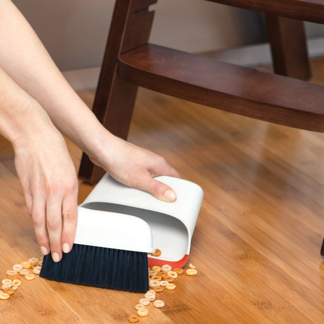 Collecting dry food crumbs in a reference kitchen scene, not a FINDWEAVE test.