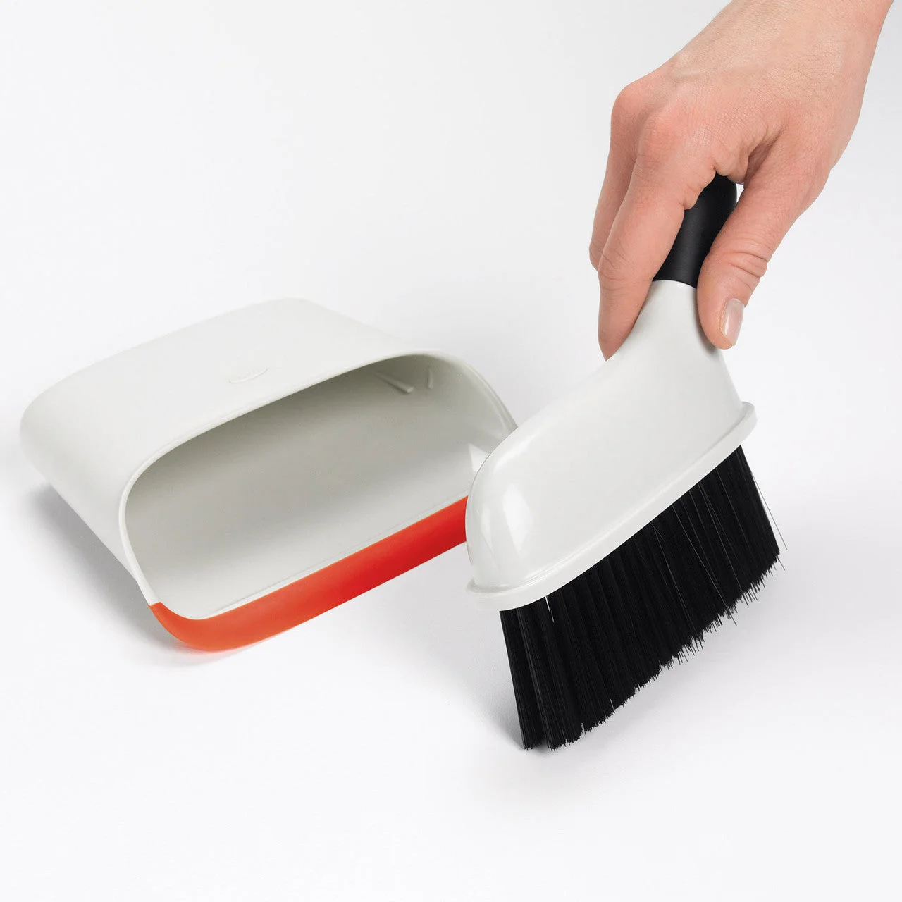 The dustpan lip and angled brush handle viewed separately.
