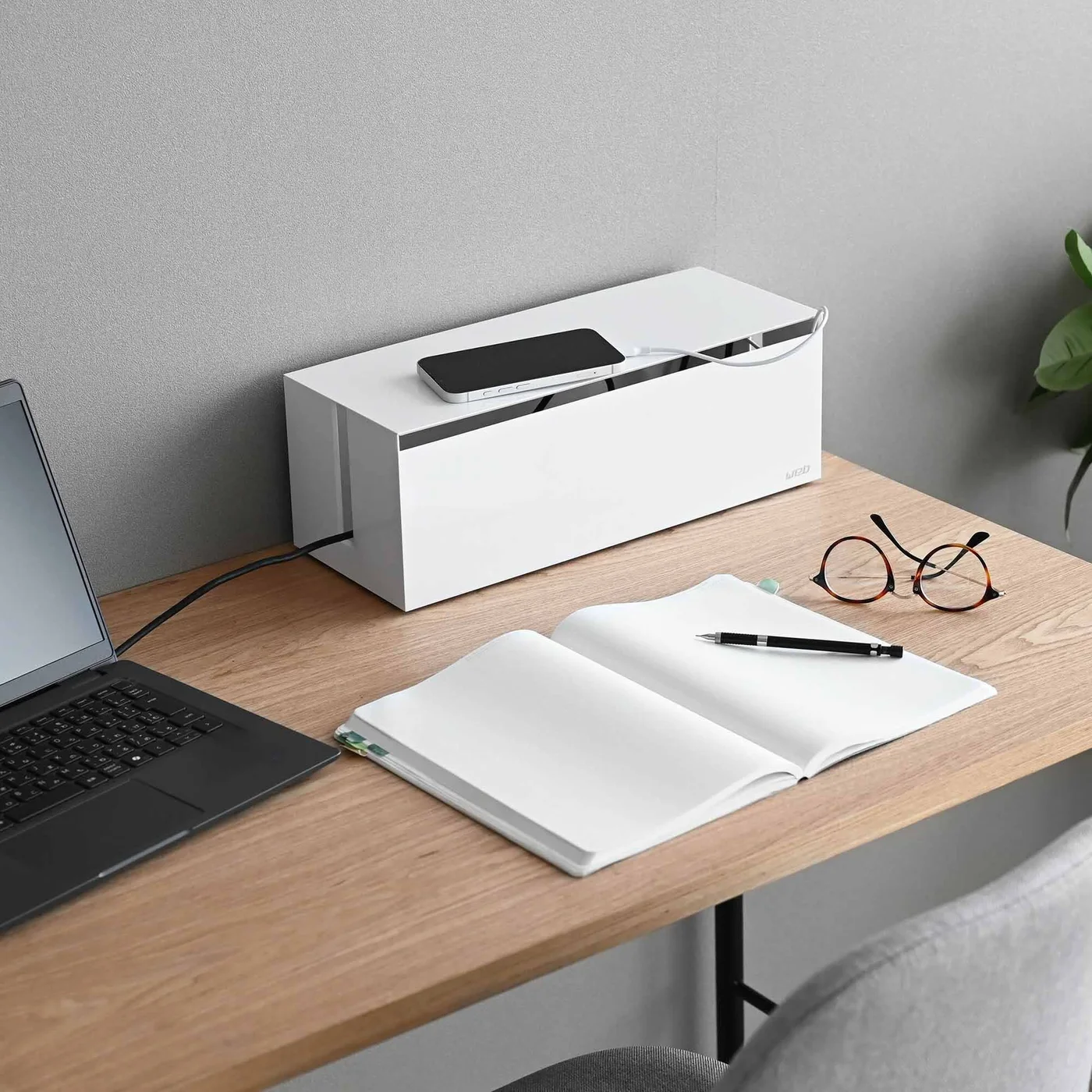 Box placed at the back of a desk.