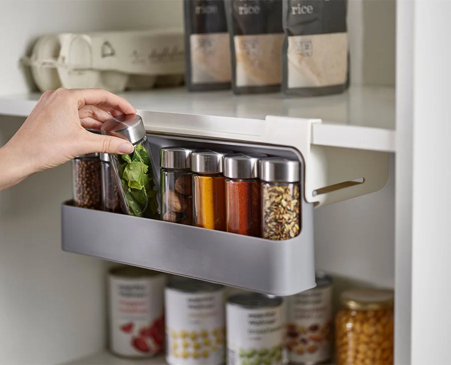 Pull-out access below an existing shelf in a manufacturer photograph.