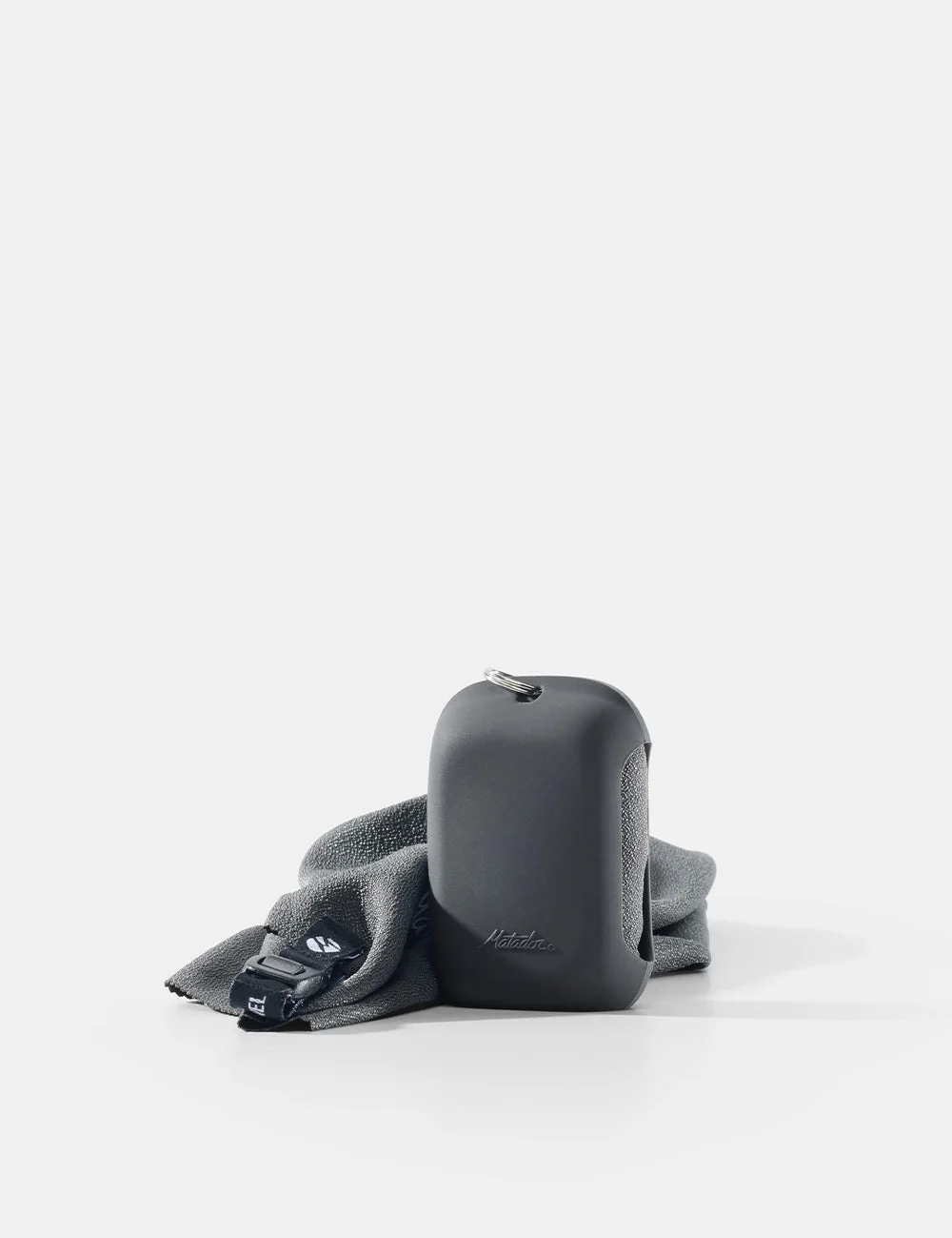 Small charcoal NanoDry towel with its compact silicone case.