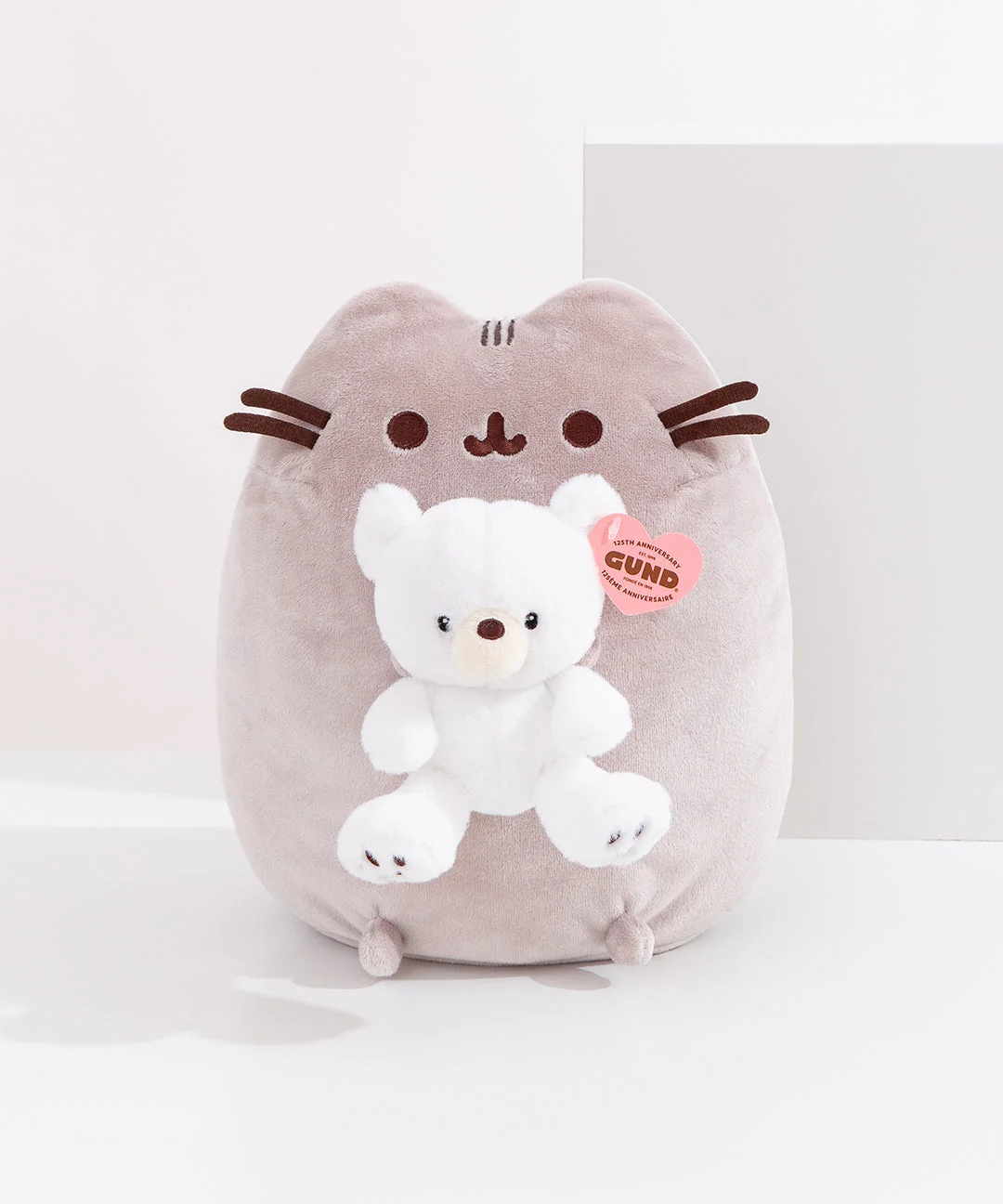 Gray Pusheen holding the white Kai bear.
