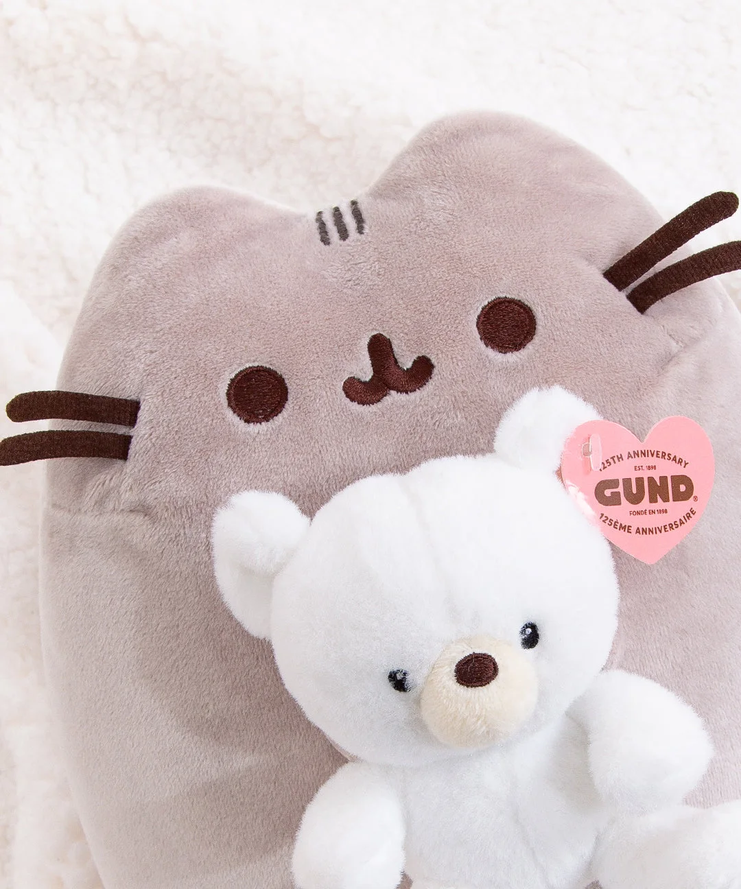 Embroidered facial details and the little teddy bear.