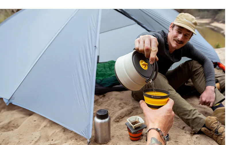 Manufacturer camping scene illustrating the design in yellow, not the linked Aqua Sea colour; cookware and other equipment are separate.