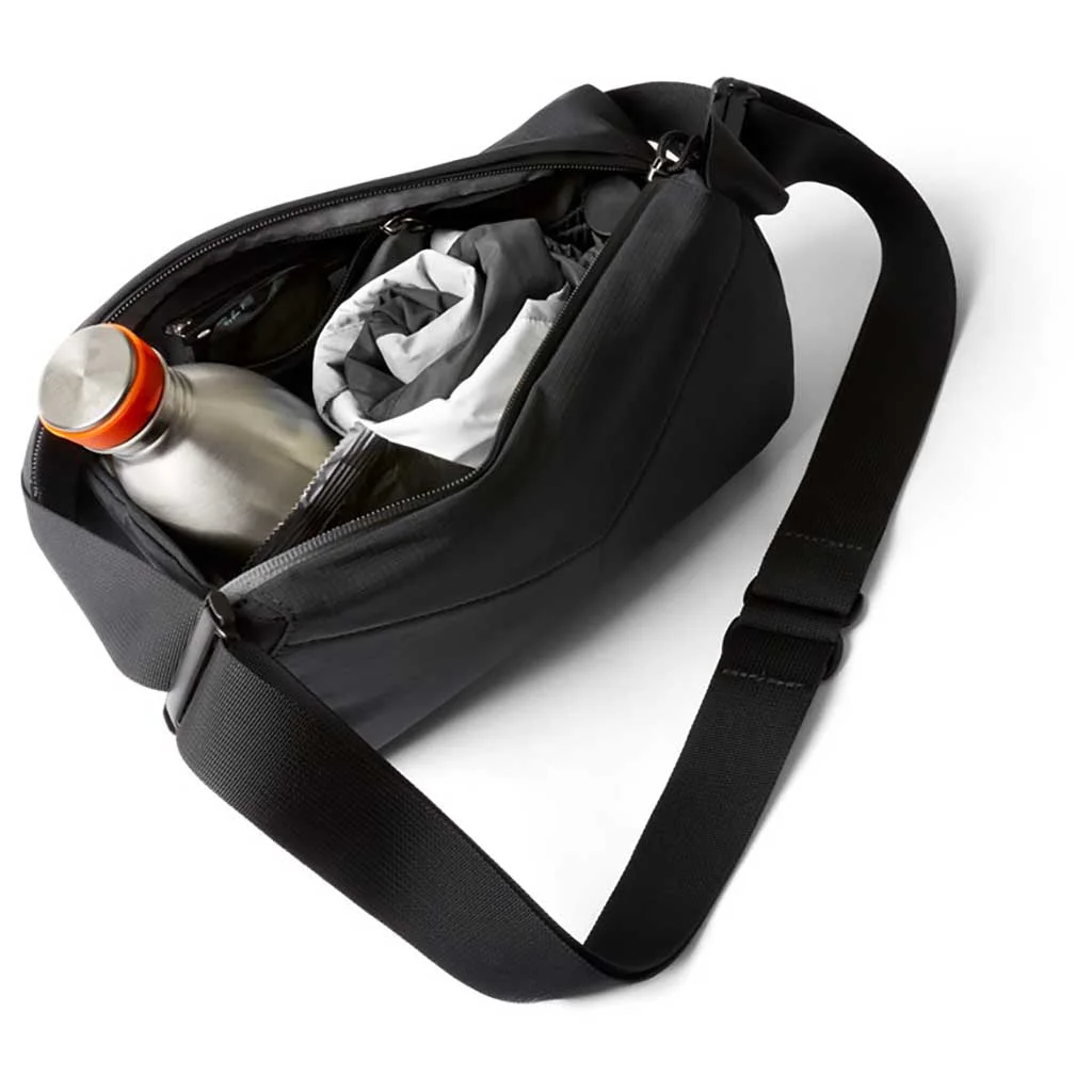 Wide-opening main compartment shown with example belongings; contents are not included.