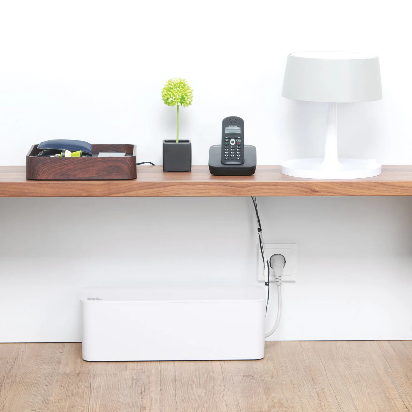 White CableBox beneath a console; check fit, access and ventilation for your setup.