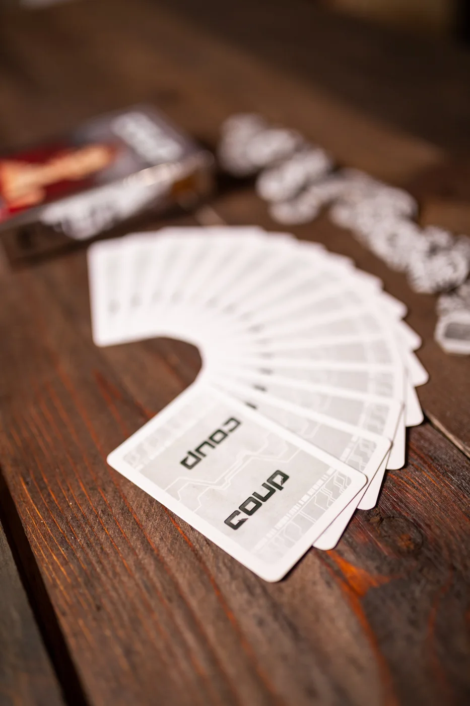 The concealed card backs and coin tokens on a tabletop.
