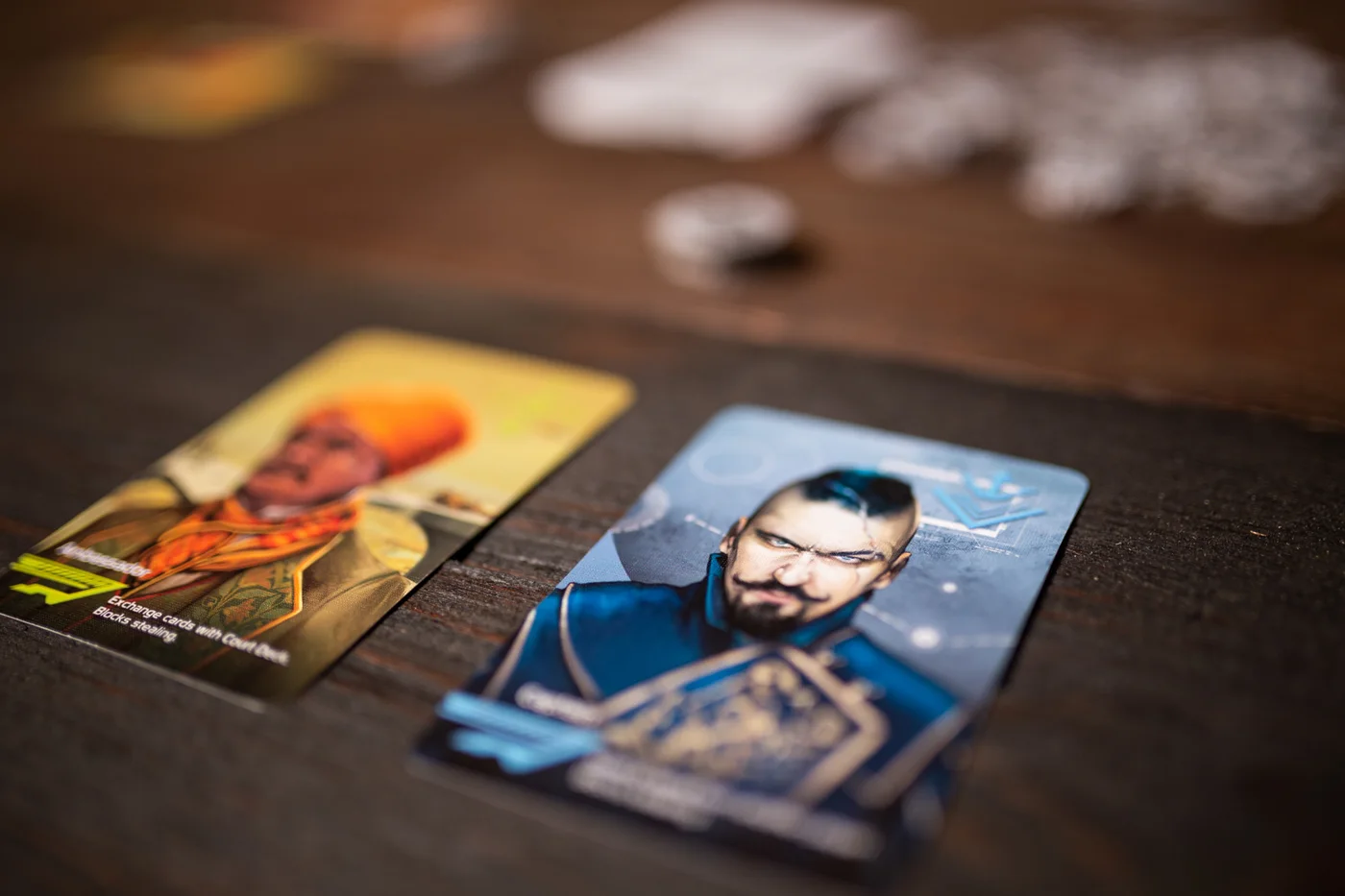 More of the original game's character cards beside coin tokens.