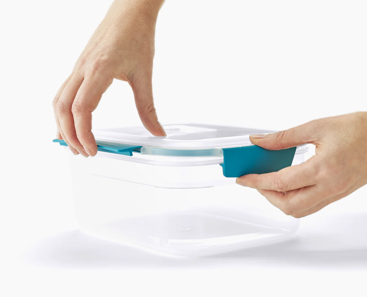 Closing a blue clip on the matching container lid.