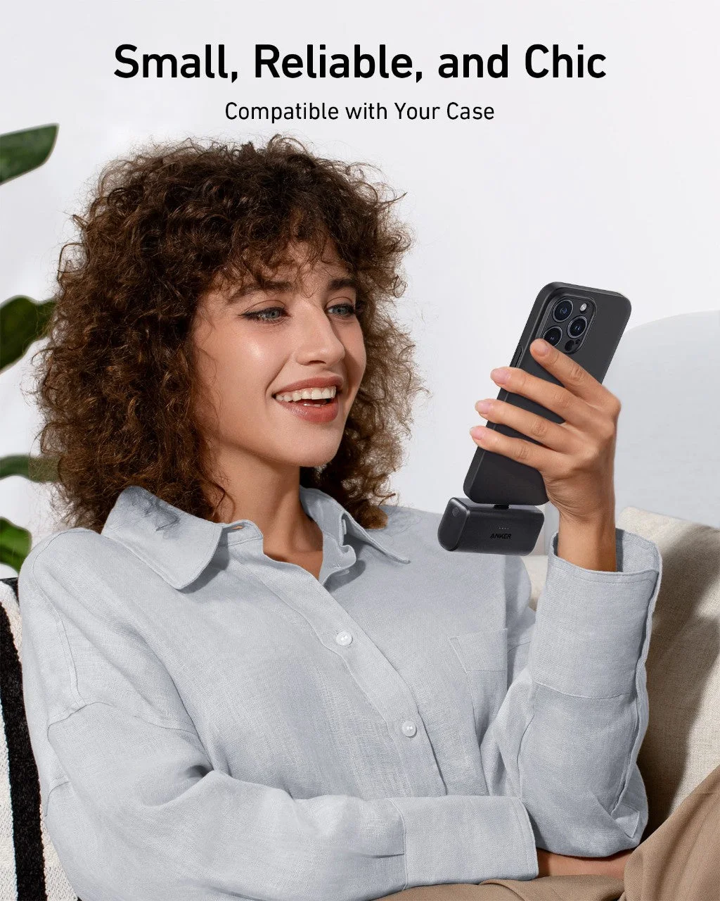 Selected blue power bank in the manufacturer's phone-use scene; hold both devices rather than letting the connector carry their weight.