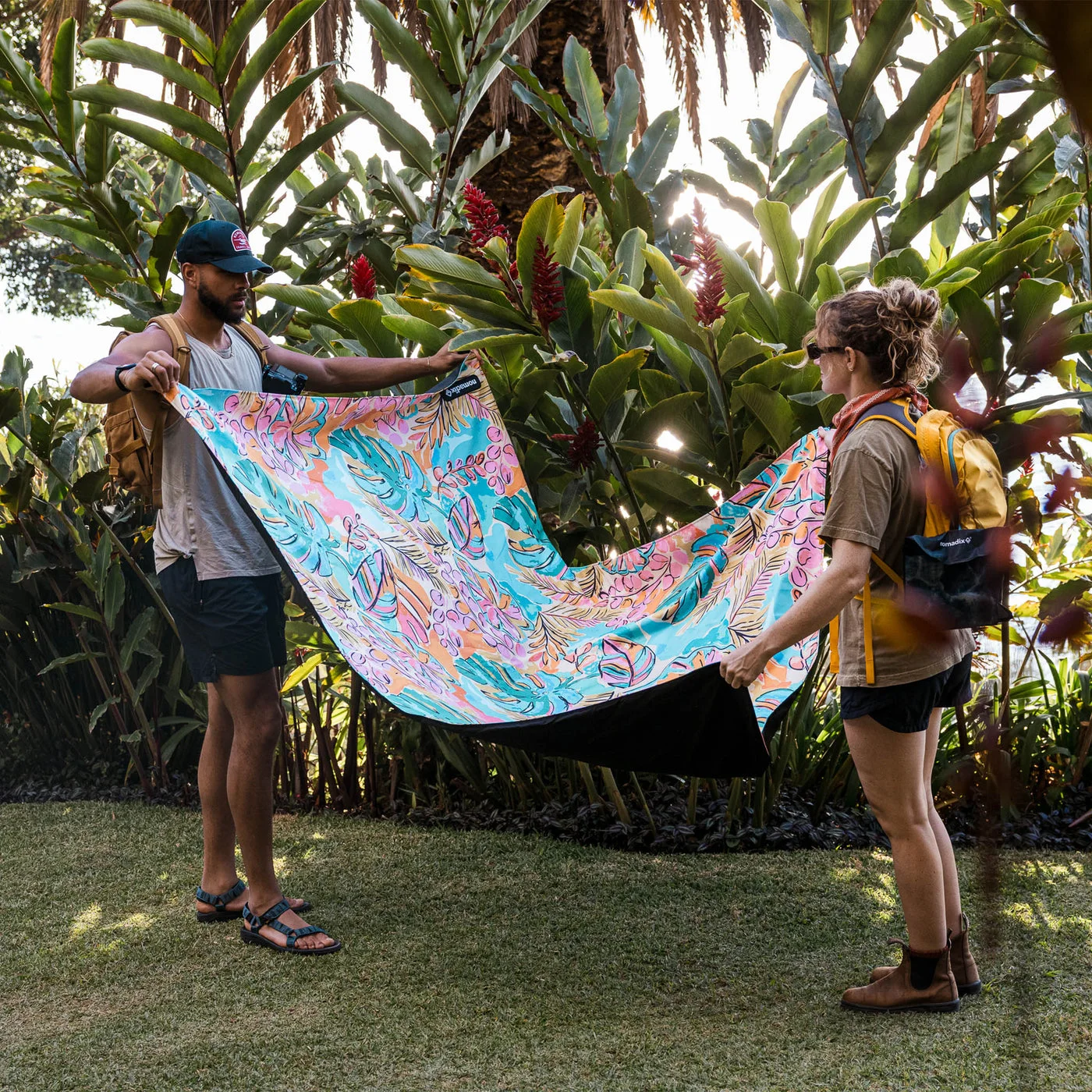 The Jungle print held open outdoors; this is a ground blanket, not an insulated sleeping bag.