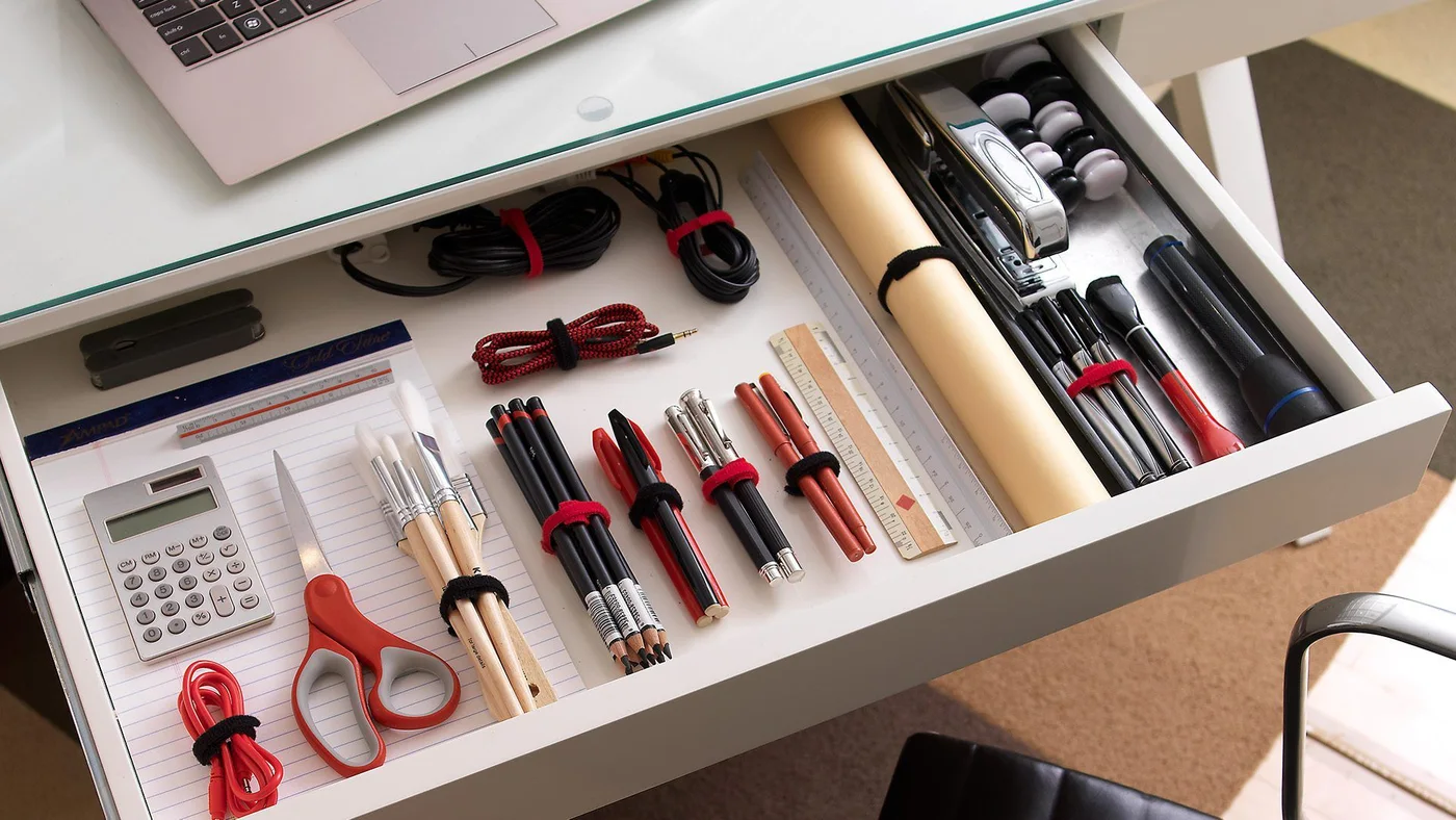 Maker drawer-organization example uses a range of tie colours; the linked pack is black, and drawer contents are not included.