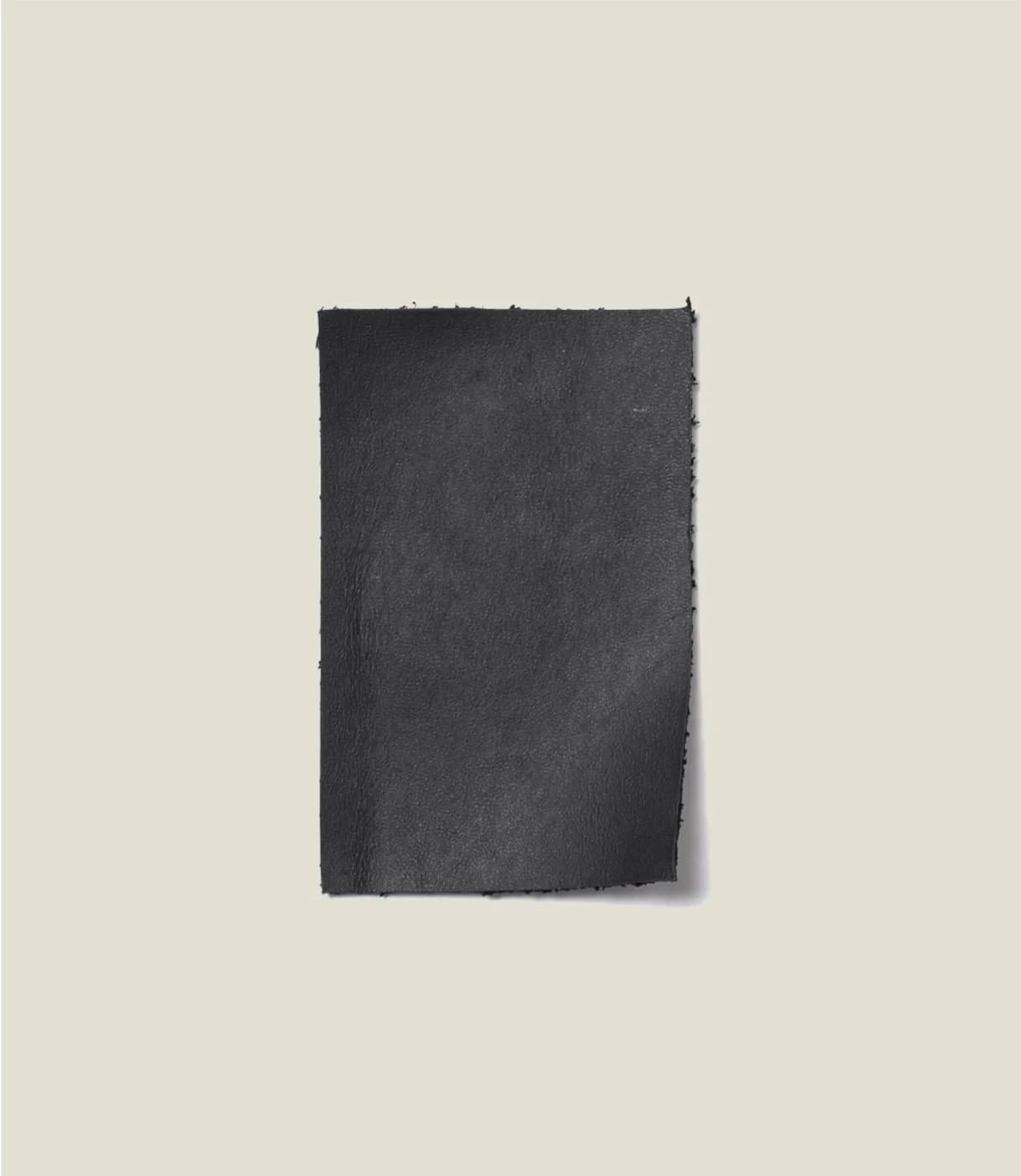 The maker's Original leather swatch illustrates the smooth black material, not a second included accessory.