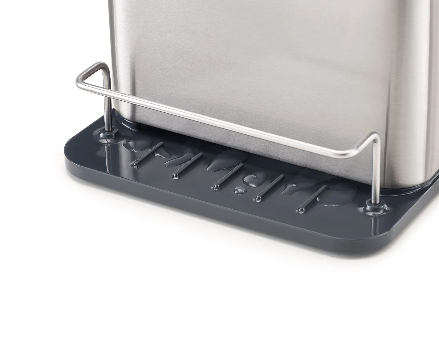 Close-up of the front rail and drainage base; the caddy still needs regular emptying and cleaning.