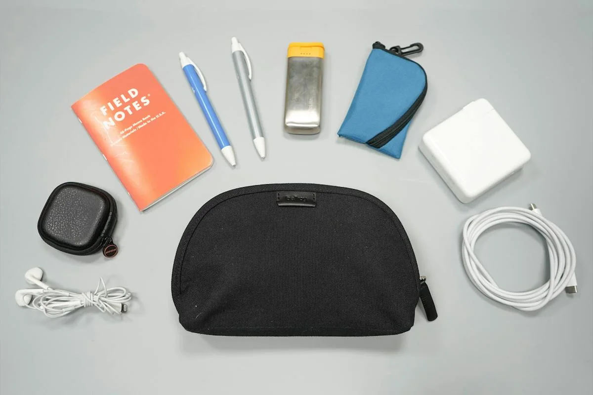 Pack Hacker reference flat lay with small everyday items; pictured contents are props, not included.