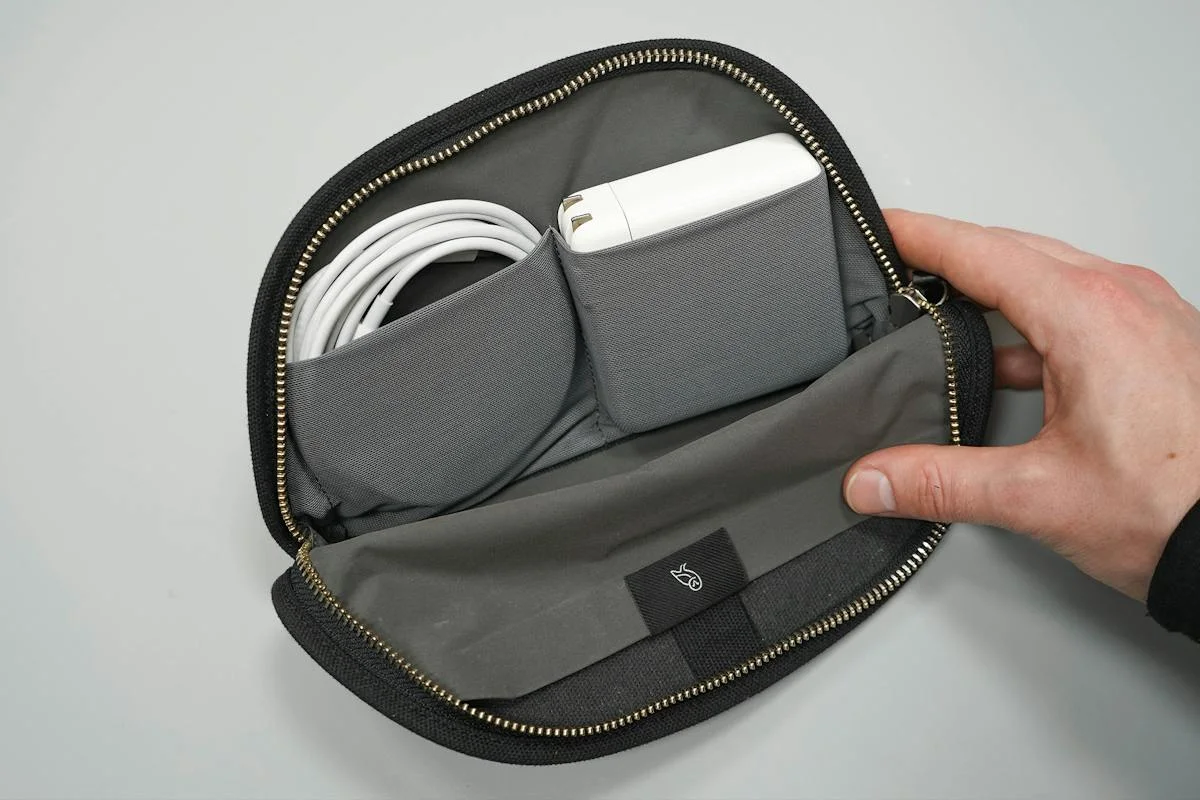 Open pouch and mesh-pocket layout with example electronics; not our testing.