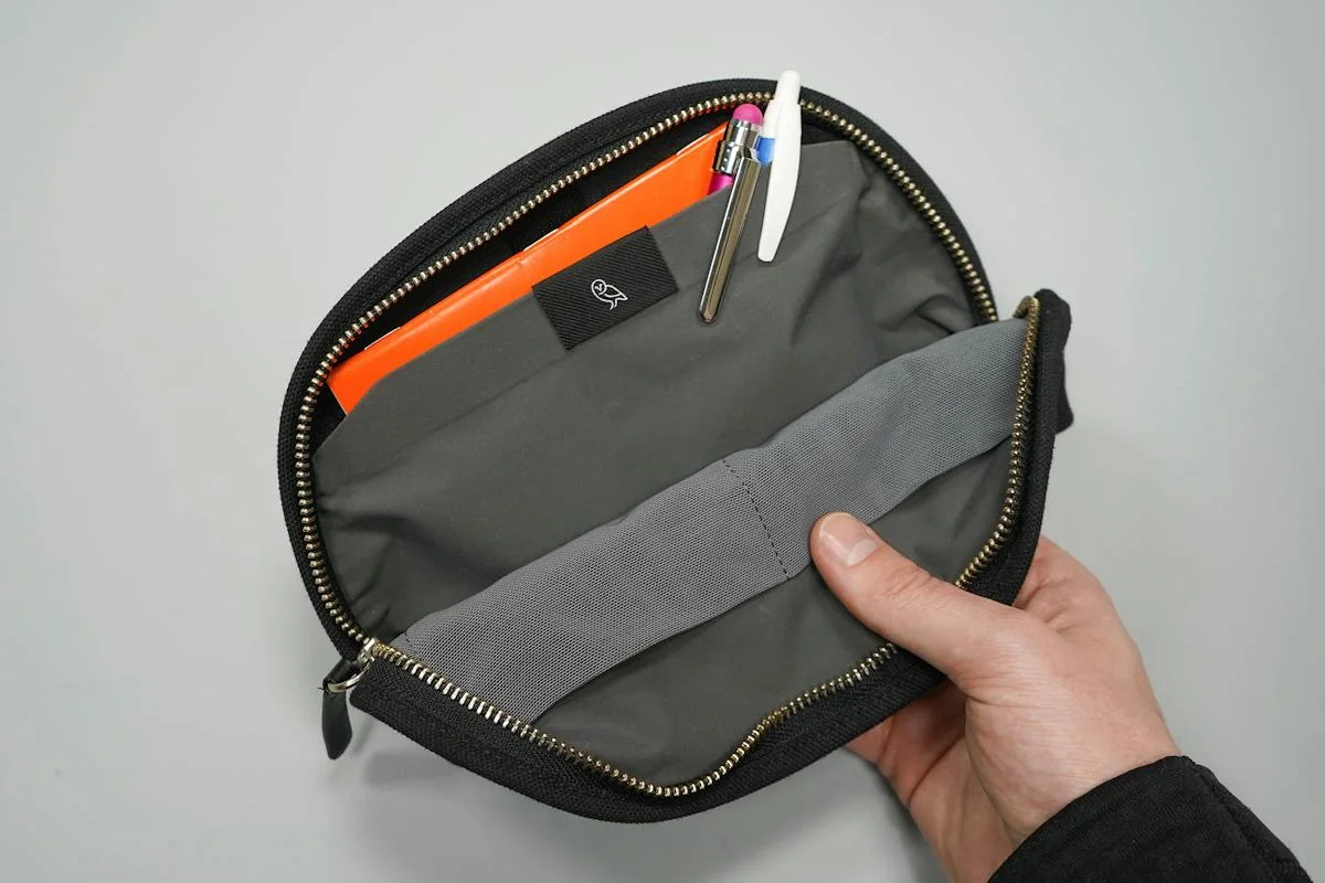 Reference photograph demonstrates internal stationery storage; pens are not included.