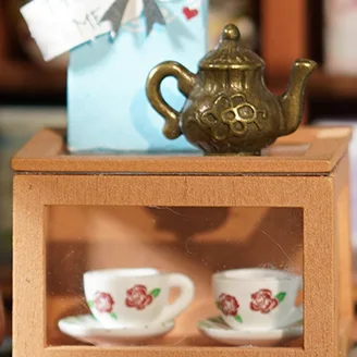 Miniature teapot and cup shelf detail