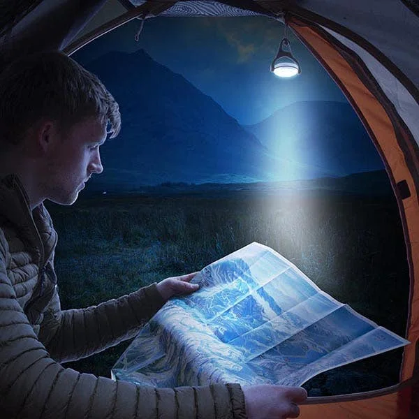 Maker-staged tent scene illustrates aimed white light; no independent brightness test is claimed.