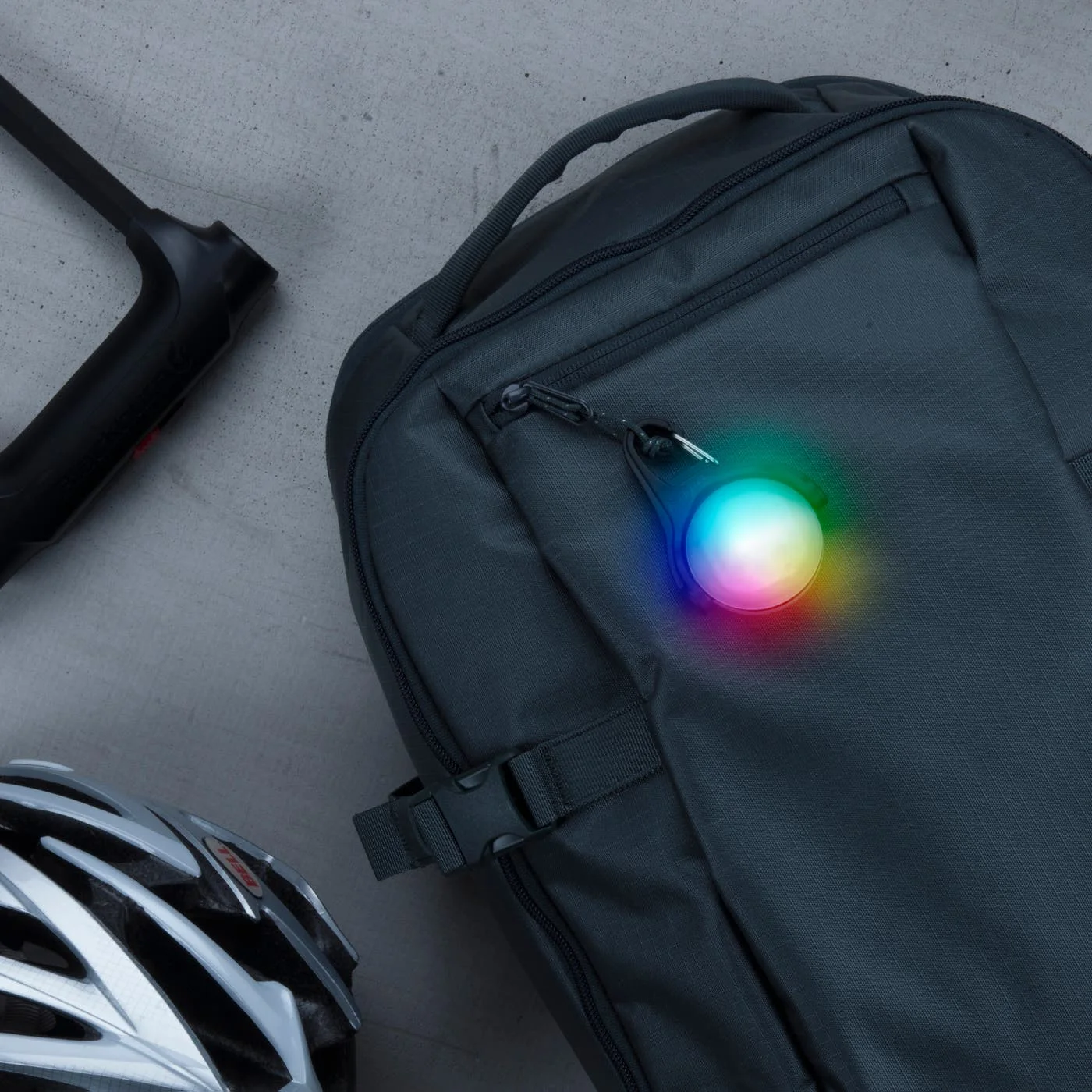 Backpack attachment example from the maker; not a substitute for approved road-safety lighting.