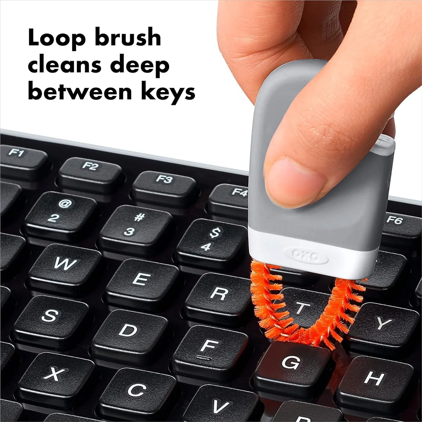 Loop-brush shape illustrated between keyboard keys; follow the device care instructions.