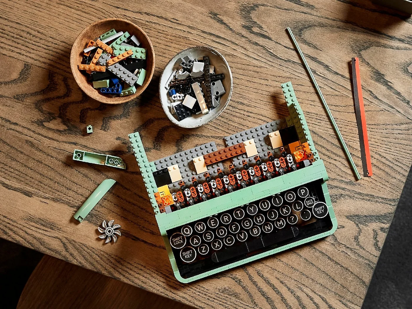 In-progress keyboard and mechanisms on a worktable; reference tools and props are not supplied.
