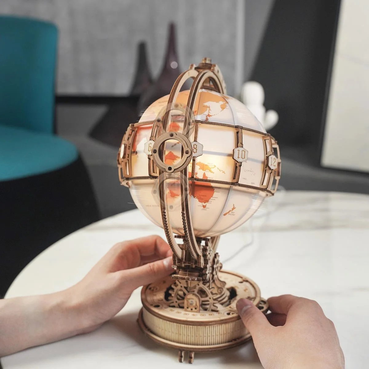 Maker demonstration of handling the finished globe