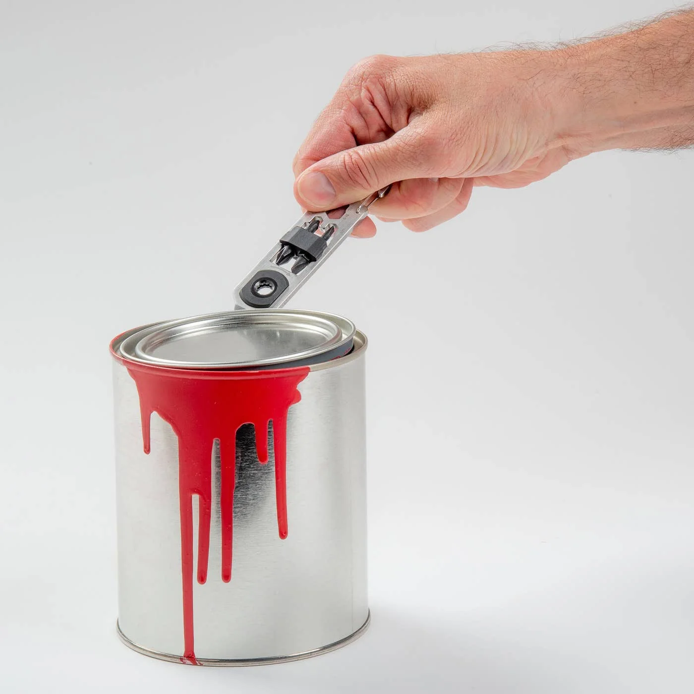 Pry-tip demonstration on a lid, not a claim of suitability for every sealed container.