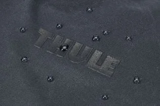 Water beads on the waxed fabric; this is not a waterproofing or immersion test.
