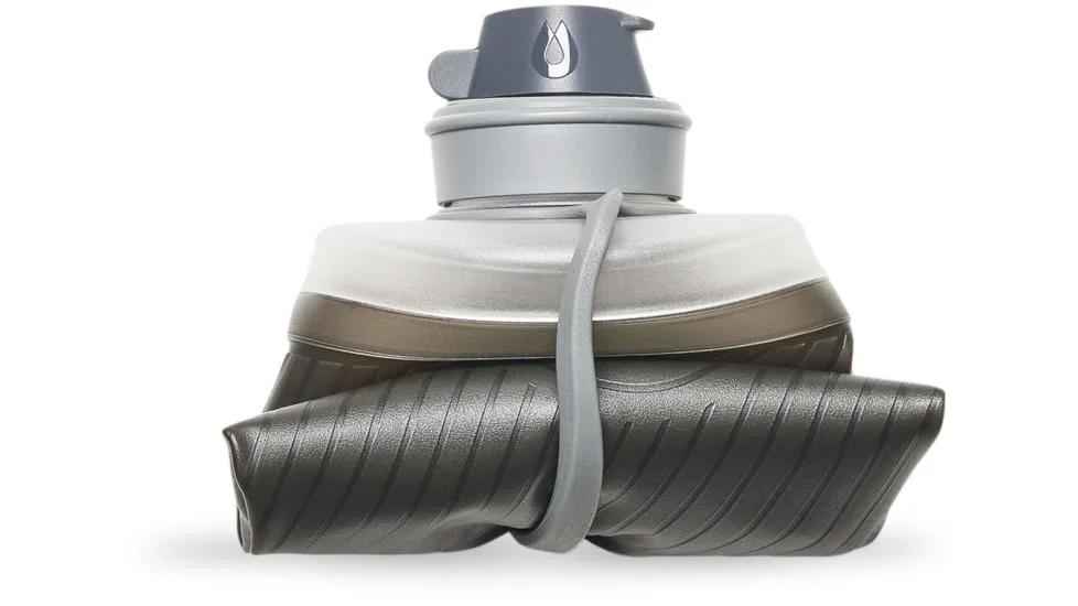 The empty flexible bottle folds down; the cap remains rigid, so packed size is not zero.