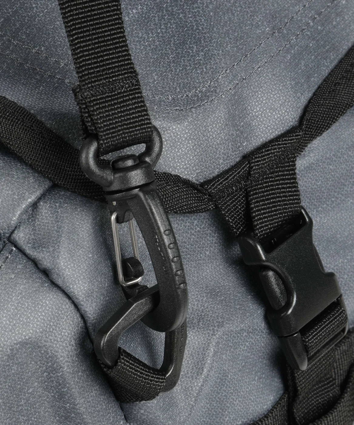 Strap attachment and buckle detail on the selected Charcoal duffel.